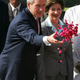 US President George W. Bush (L) scatters rose petals as first lady Laura Bush watches at the Mahatma Gandhi memorial at Rajghat in New Delhi March 2, 2006. Bush was given a grand reception in India on Thursday as officials from both countries edged closer to a landmark nuclear deal and communist and Islamist groups vowed more mass protests.